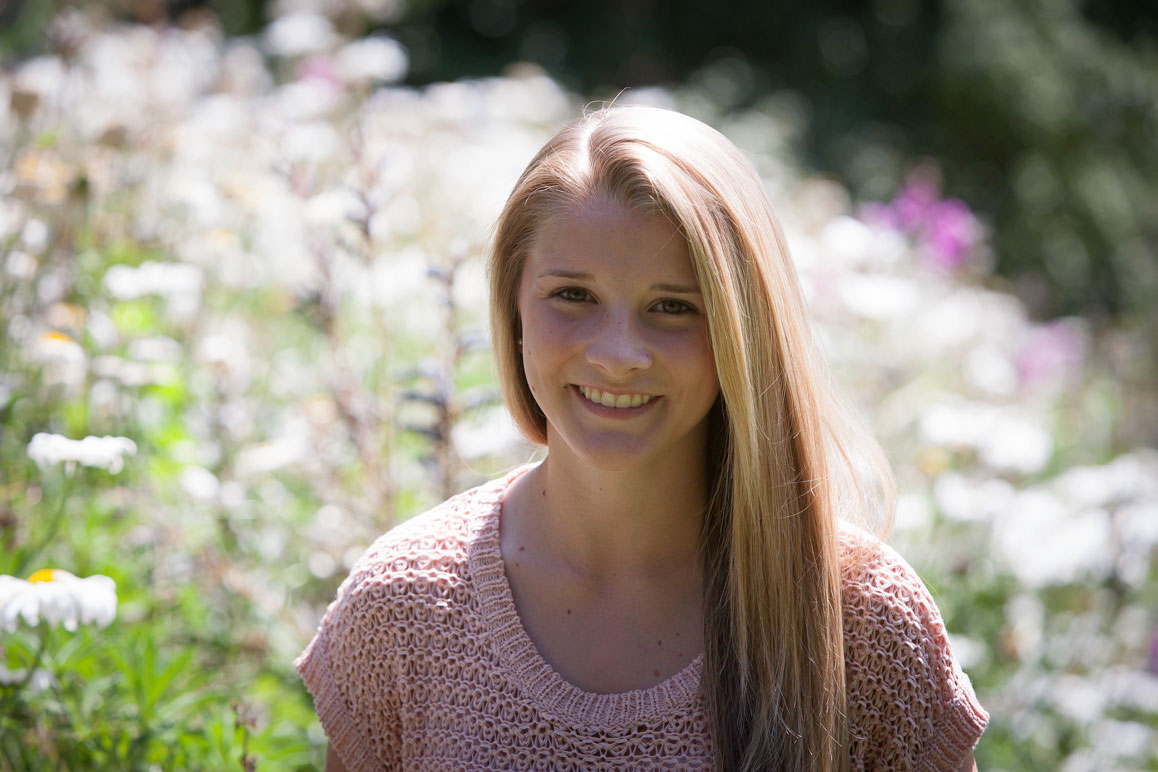 Close up photo of senior girl in flowers at Chism Beach Park